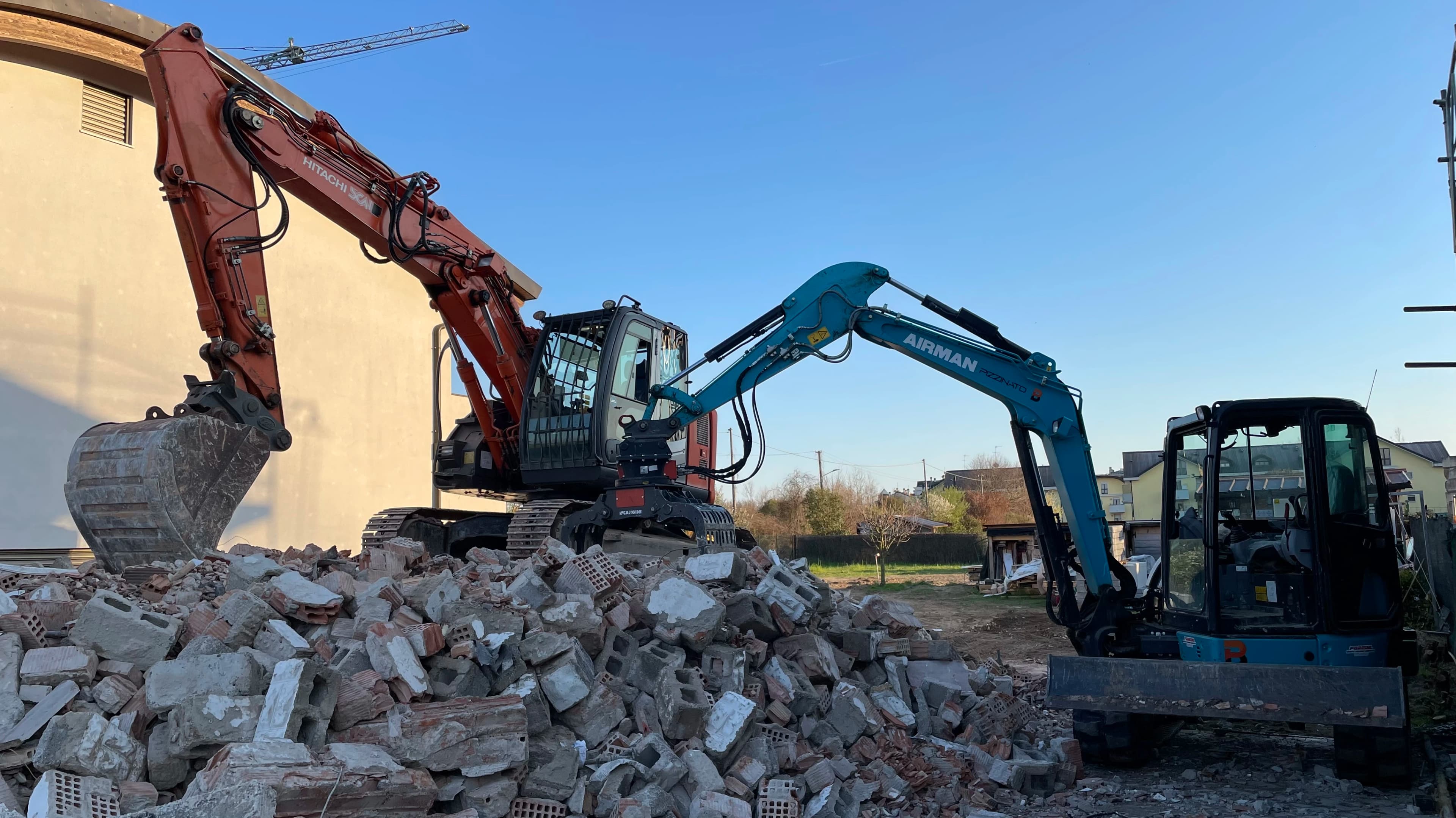 Wide shot of a demolition site with dust clouds